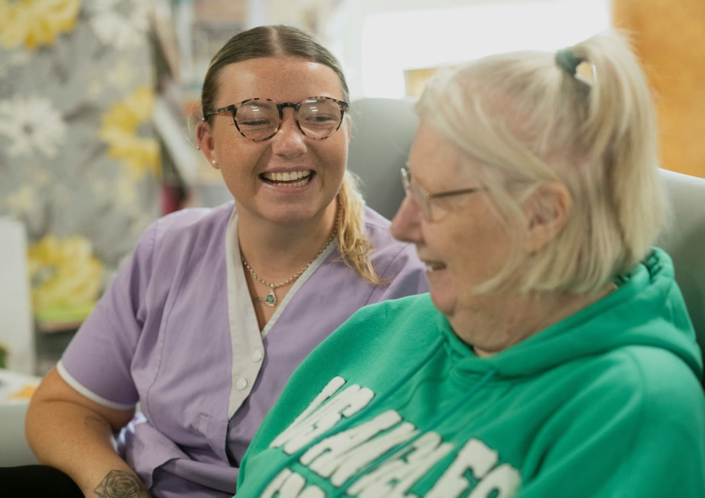 A MeddyCare carer sharing a warm moment with an older person at home.